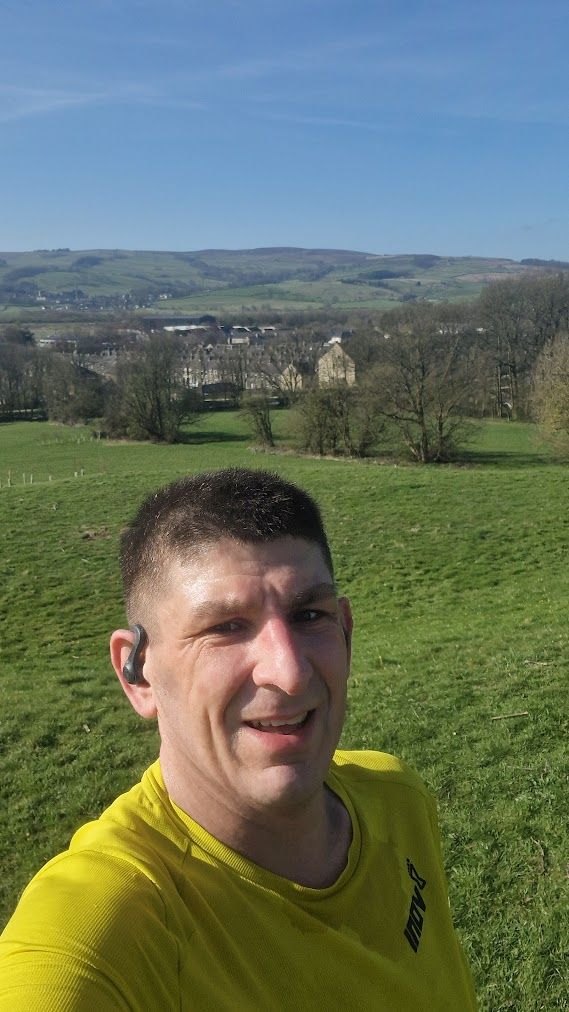 Jason Millward out on a run, with fields and hills behind